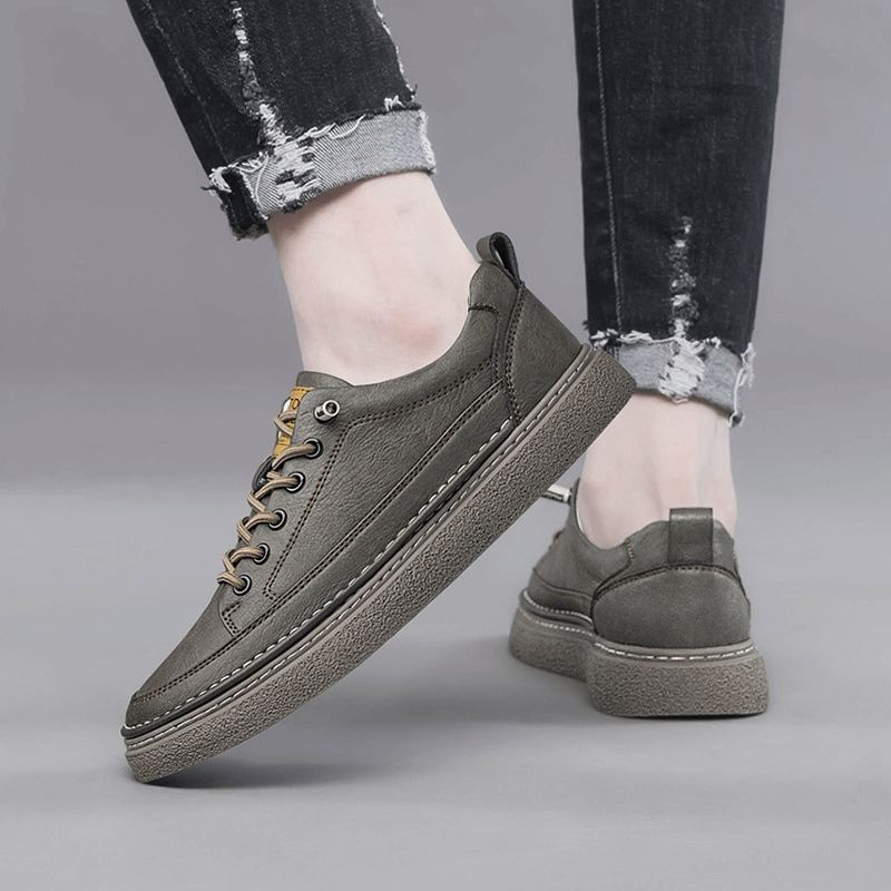 Stylish Leather Breathable Men's Sneakers SF1182, shown on feet with ripped jeans, highlighting durability and comfort.